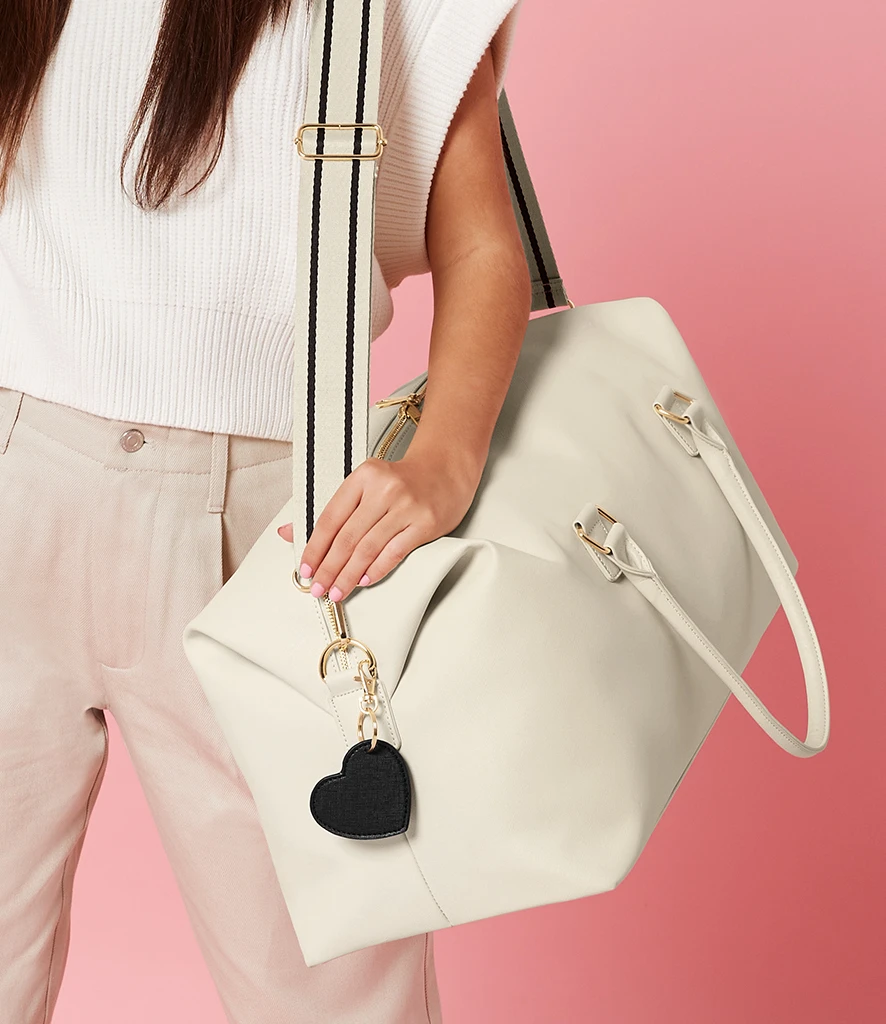 Women holding oversized weekender page in cream
