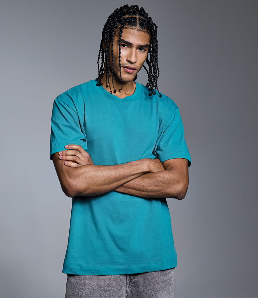 man in teal Anthem short sleeve heavyweight tshirt