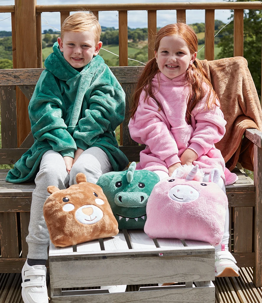 Two kids wearing hooded blankets with character cushions in front