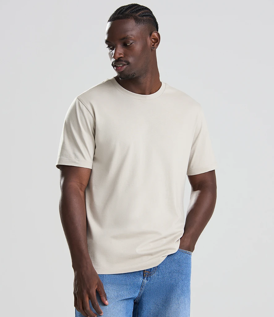 Man wearing unisex natural 100% better cotton t-shirt 