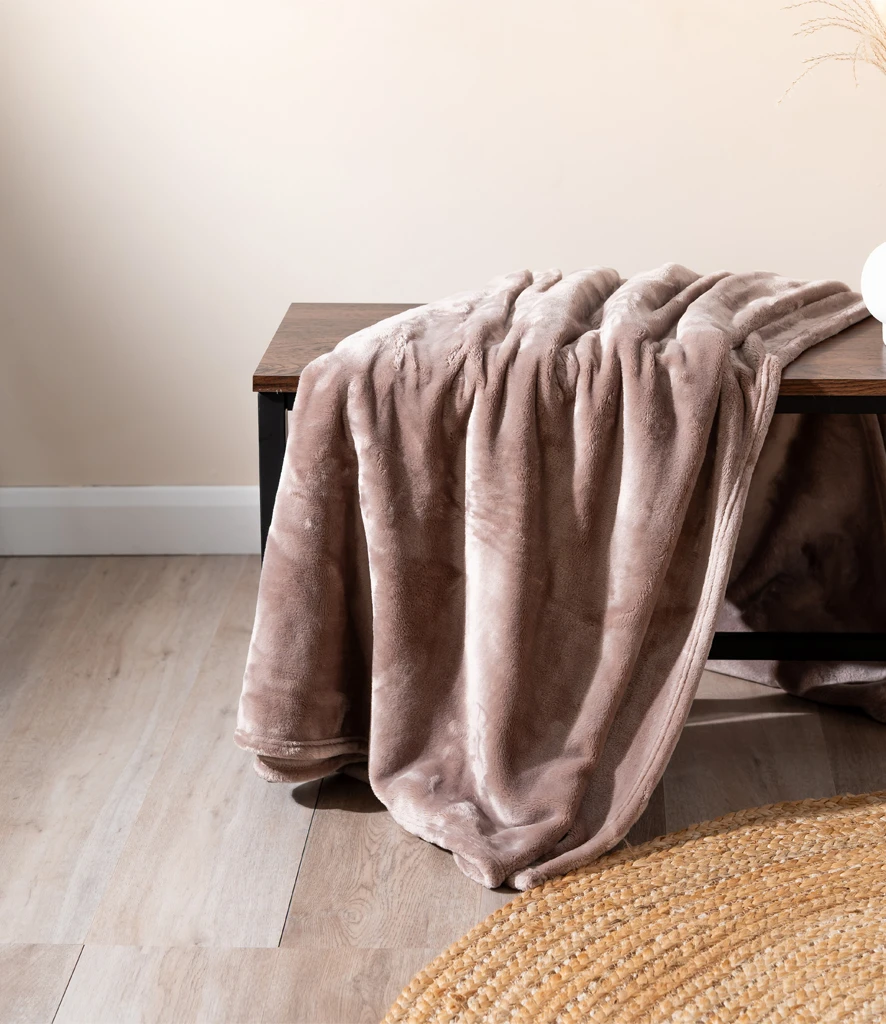 Soft Brand Lab blank blanket in earthy tone resting on bench