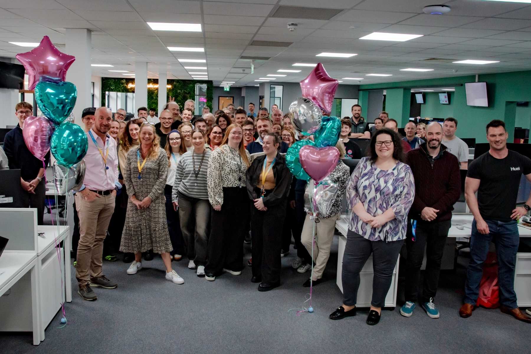 Team PenCarrie in offices group shot smiling 