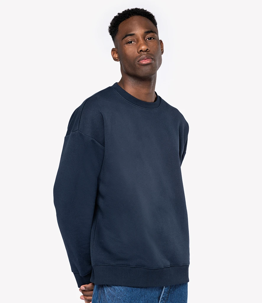 Man wearing Native Spirit unisex oversized drop shoulder sweatshirt in navy 