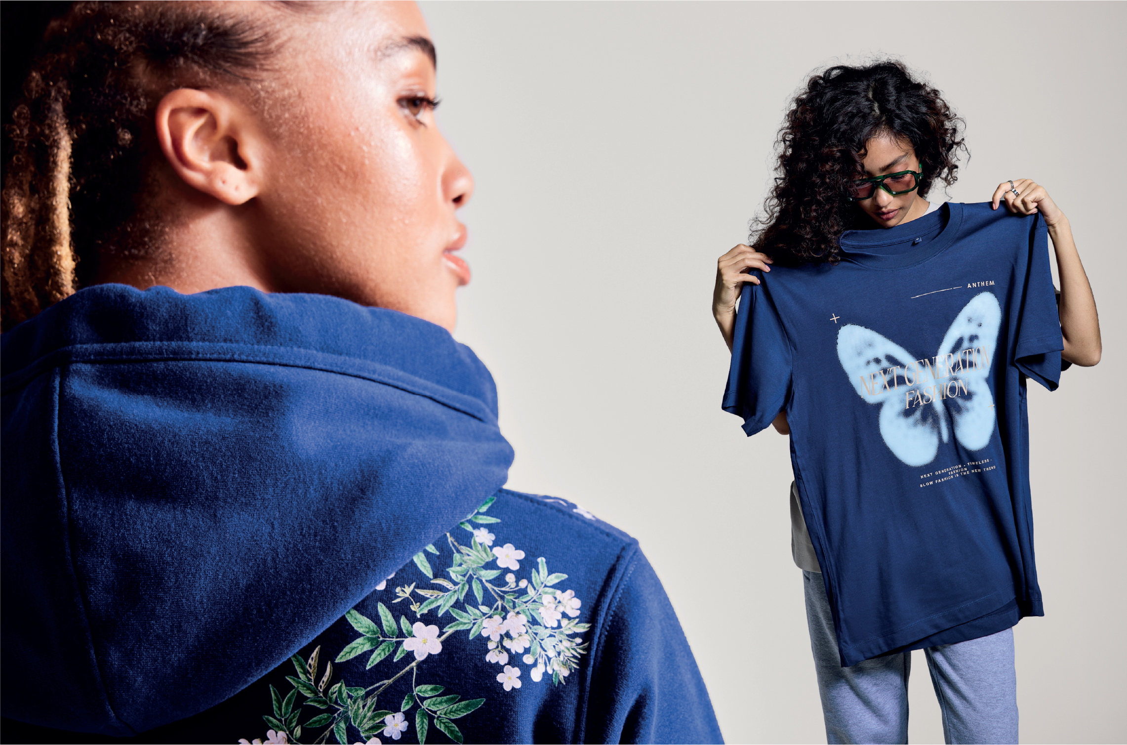 Woman holding navy tshirt with butterfly print and another woman with floral printed hoodie
