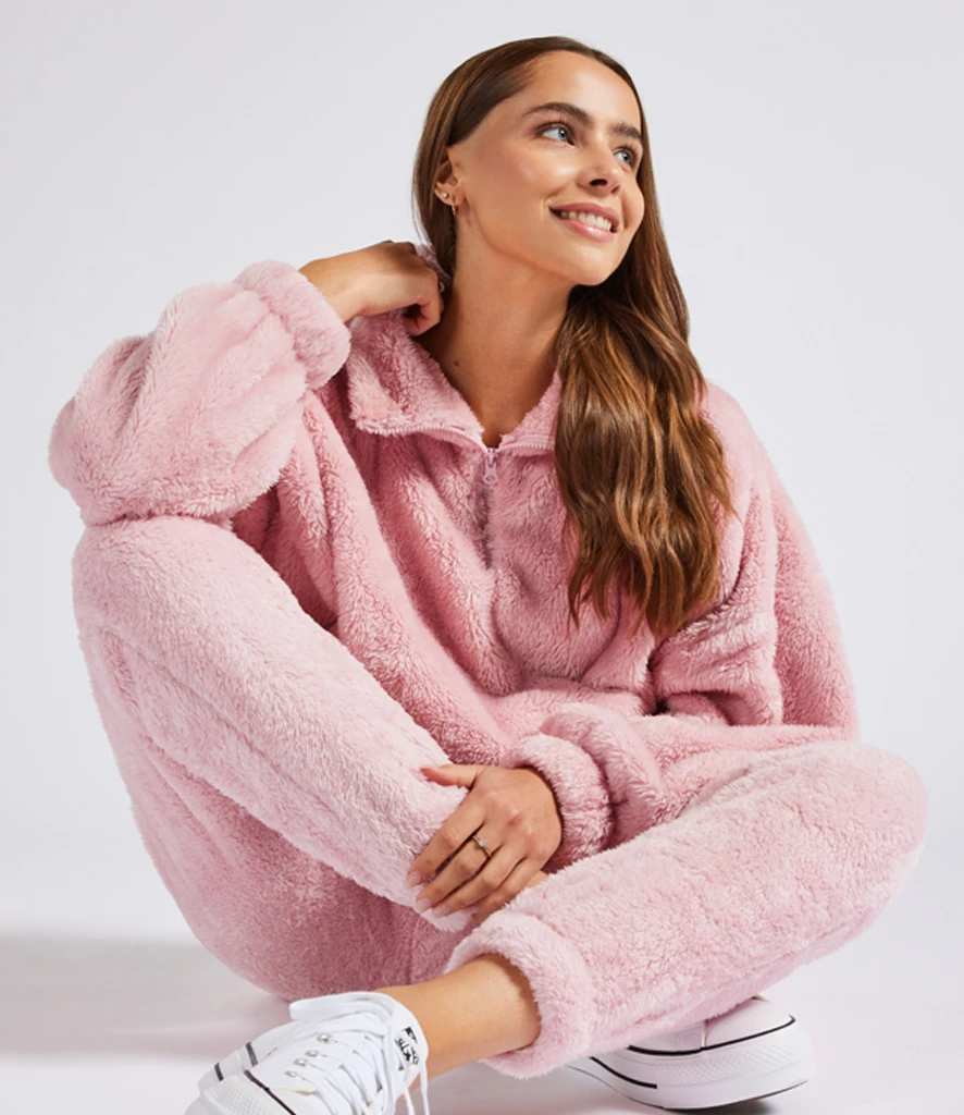 Women wearing pink fluffy 1/4 jumper with matching trousers
